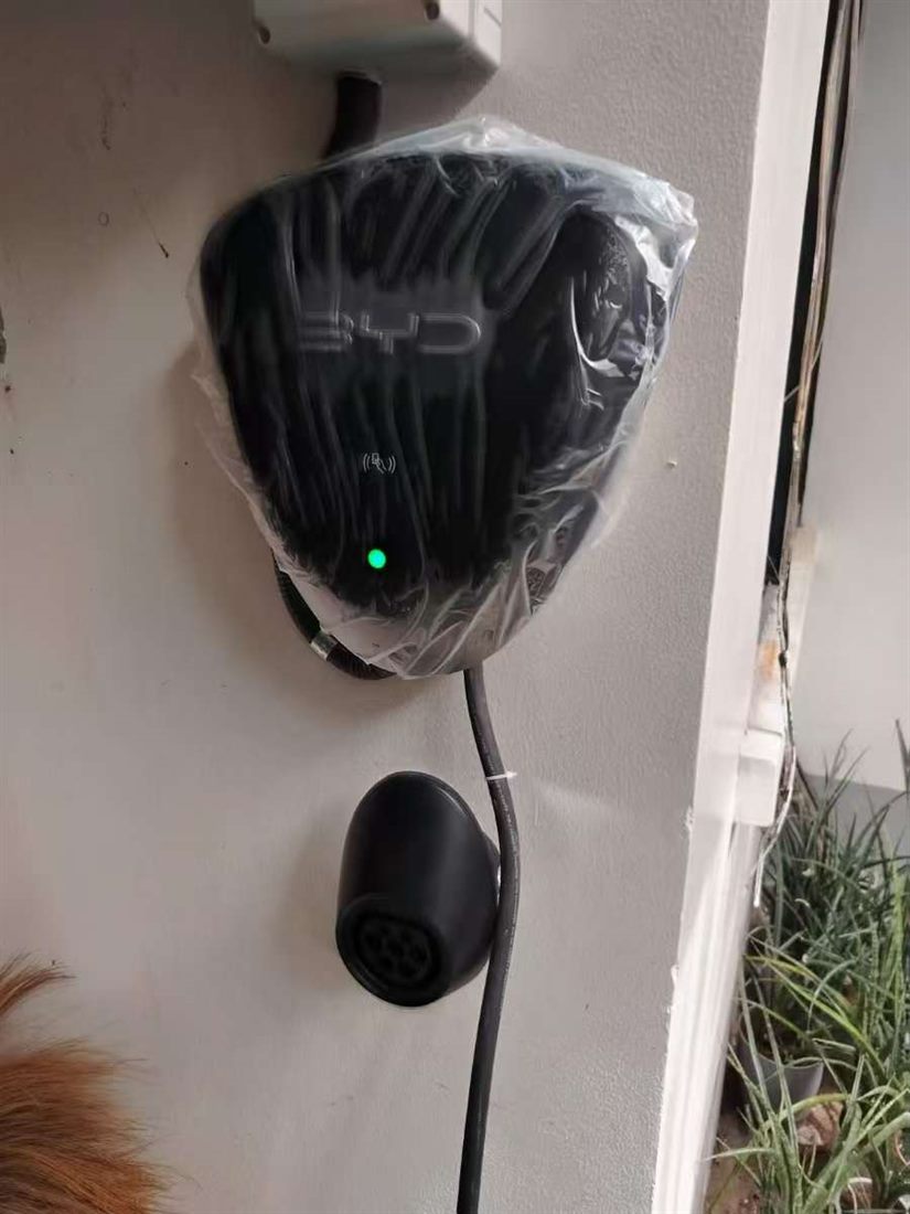 Close-up of an installed BYD wall charger and charging connector