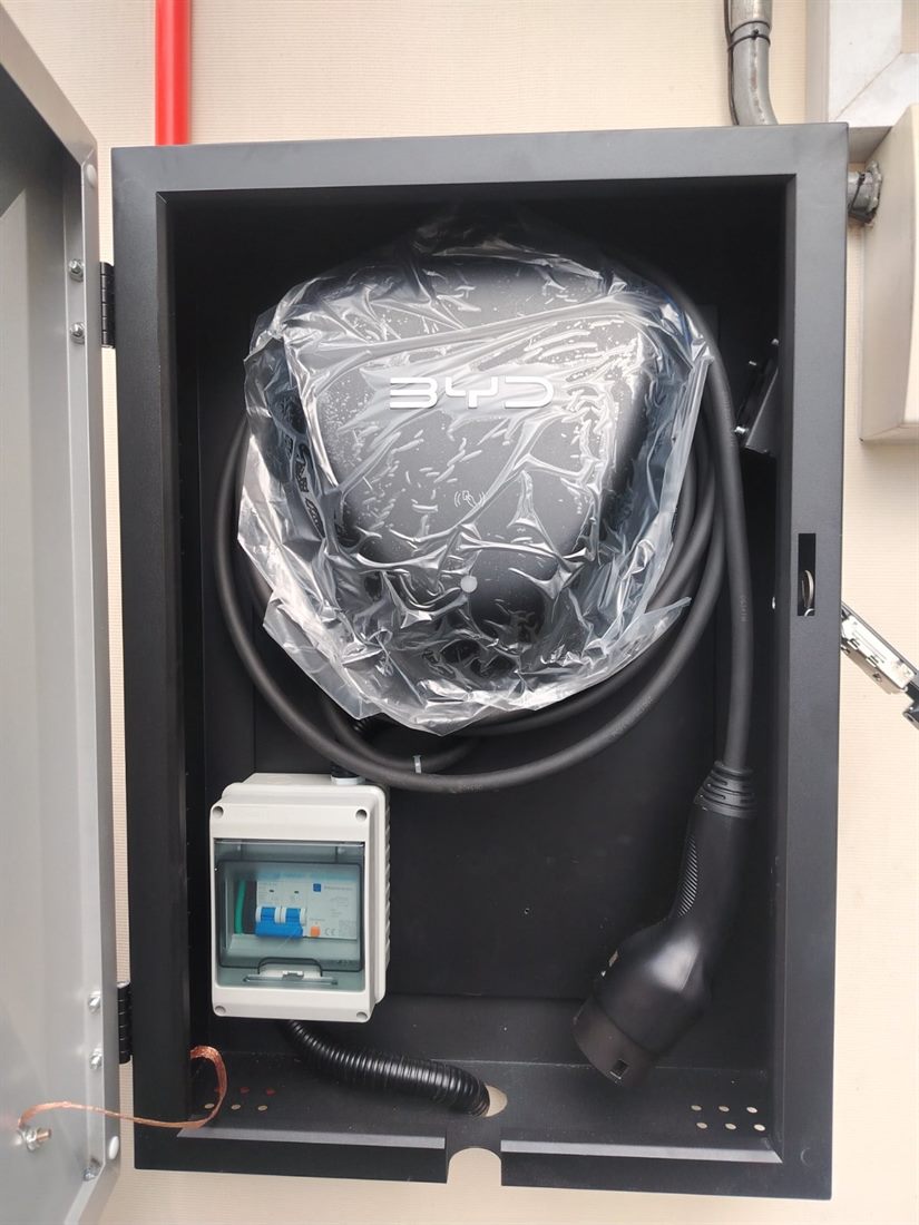 BYD charging equipment mounted in a protective enclosure with metering