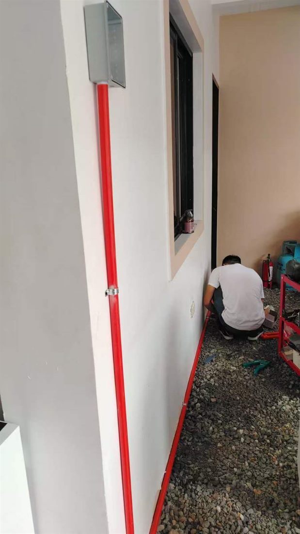Brothers Energy technician installing conduit and wiring for a BYD wall charger